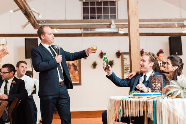 Best man toasting bride and groom