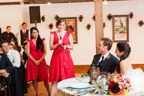 Bridesmaid in pink dress giving speech