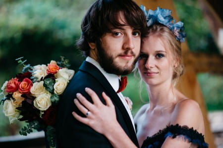 Bride with hand on groom's shoulder