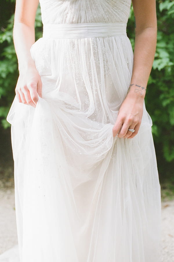 Bride pulling up wedding dress