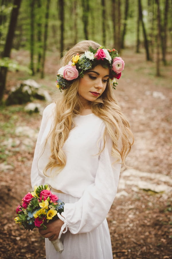 Boho bride with flower crown holding bouquet