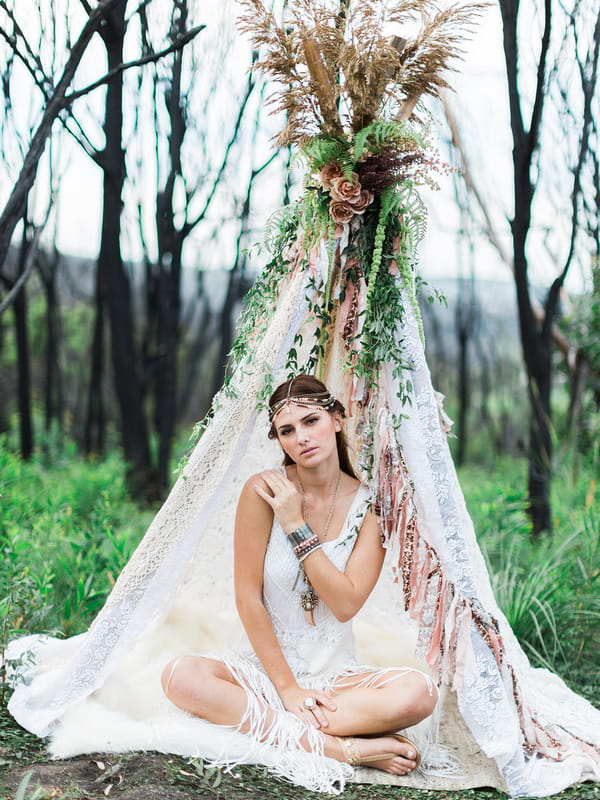 Bohemian bridesmaid in tipi with hand on shoulder