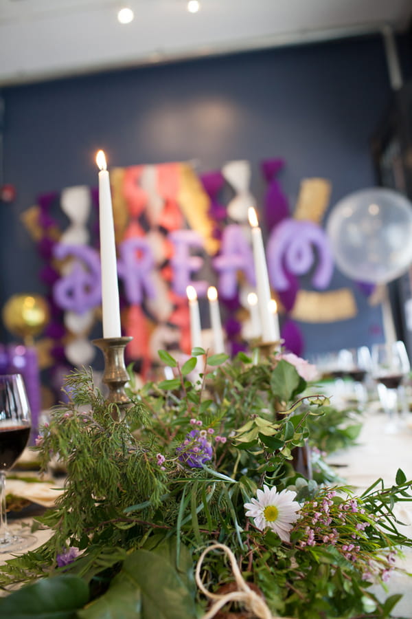 Candle and foliage wedding table centrepiece