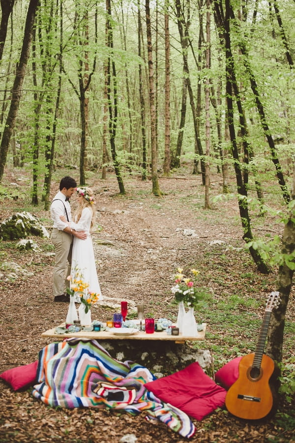 Bride and groom in woods with table