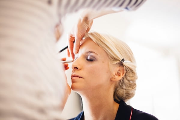 Bride having make-up done