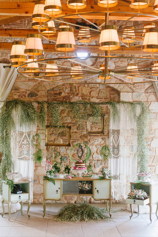 Wedding candy table decorated with ferns and foliage