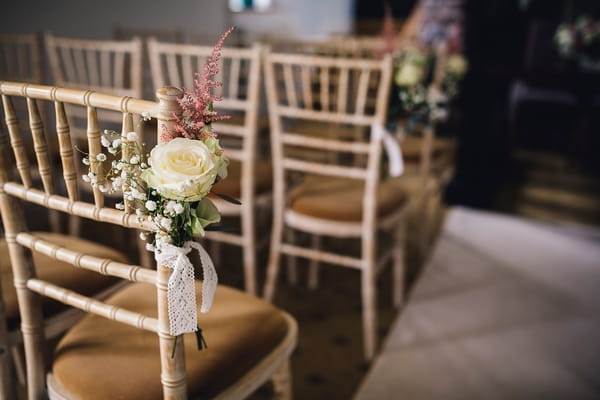 Flowers tied to end of chair