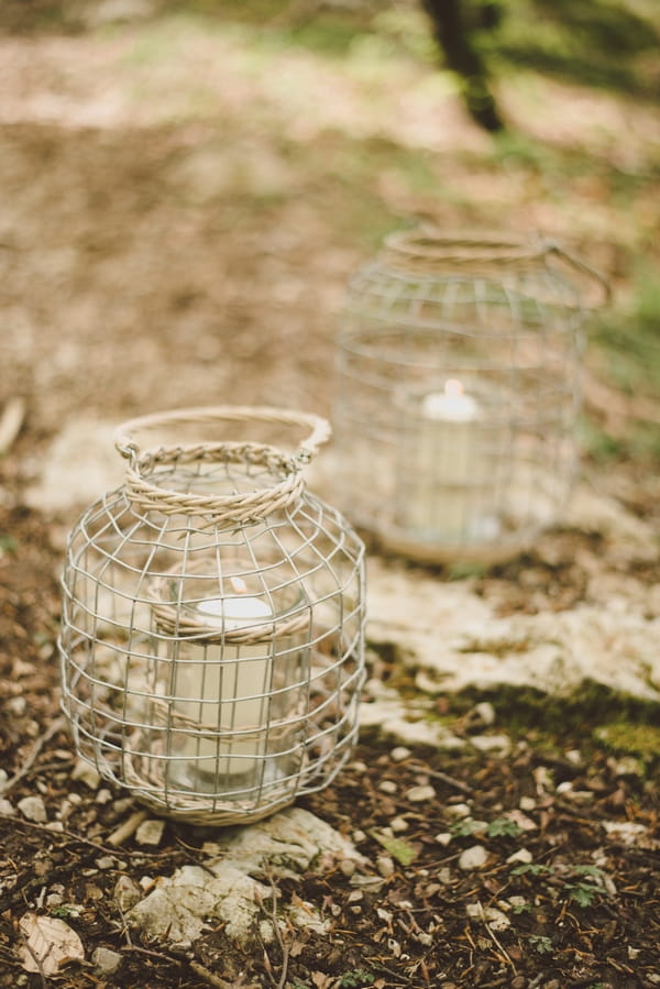 Lanterns on ground in woods