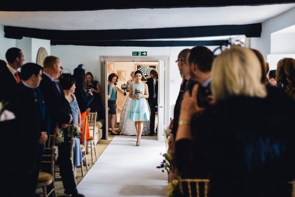 Bridesmaid walking down aisle