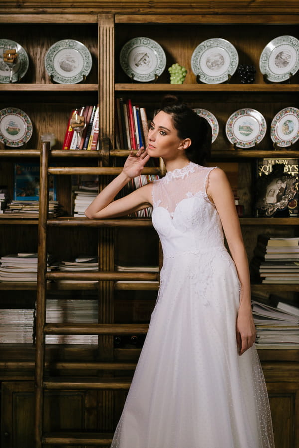 Bride leaning on shelves