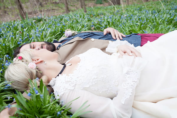 Bride and groom laying in grass