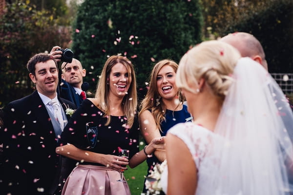 Wedding guests throwing confetti