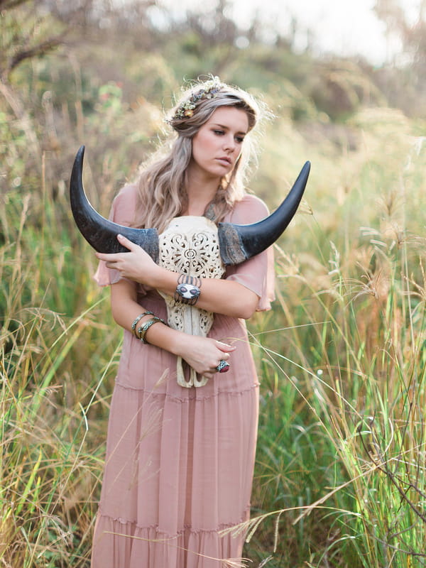 Bohemian bridesmaid holding horned skull