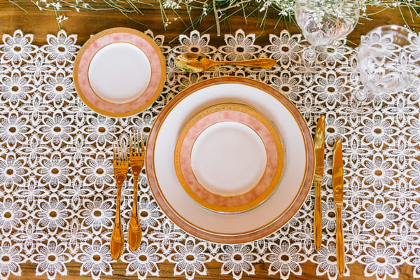 Plates on embroidered table runner