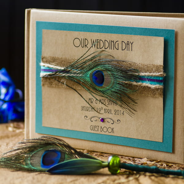 Wedding guest book with peacock feather