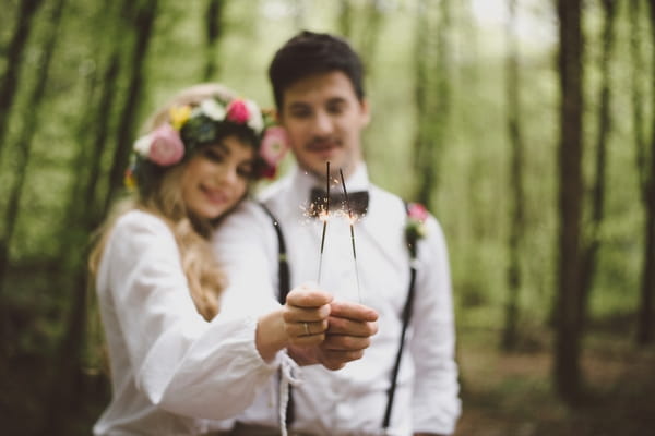 Boho bride and groom with sparklers