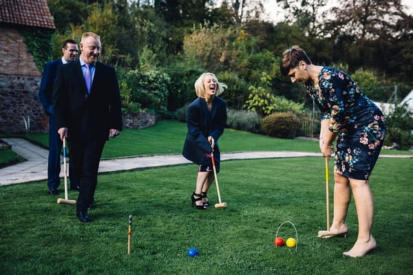 Wedding guests playing croquet