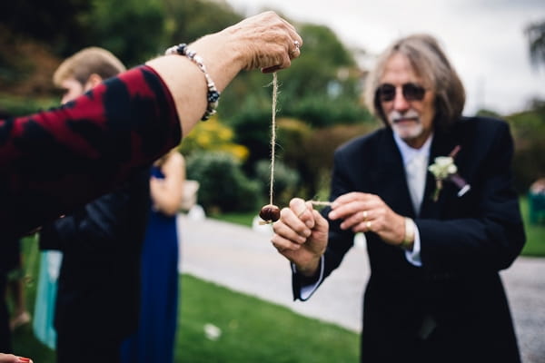 Wedding guests playing conkers