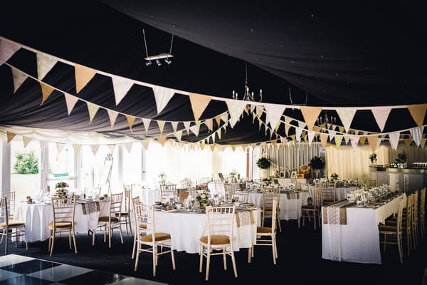 Wedding tables and bunting in marquee