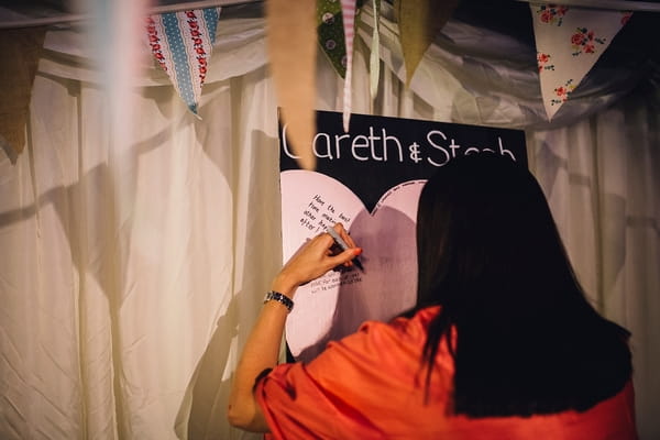 Wedding guest leaving message for bride and groom