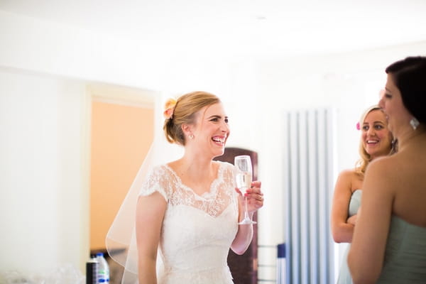 Bride drinking champagne