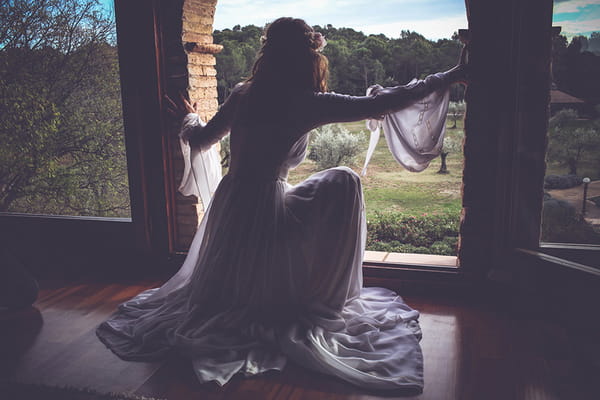 Bride crouching to look out of window