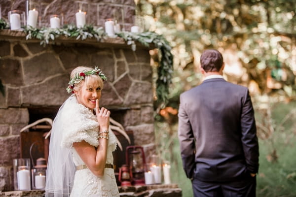 Bride sneaking up on groom