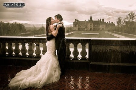 Bride and groom kissing in heavy rain - Picture by Mozingo Photography