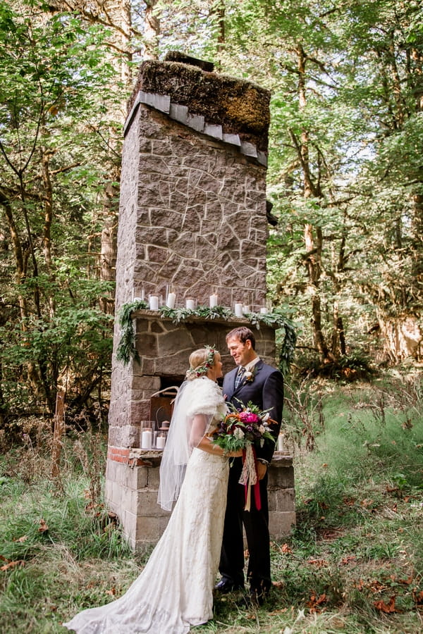 Bride and groom by stone structure