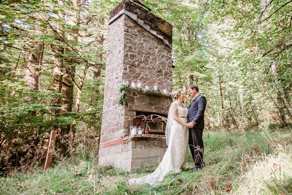 Bride and groom by stone structure