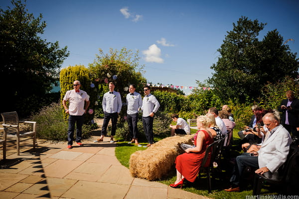 Groom and groomsmen waiting for bride