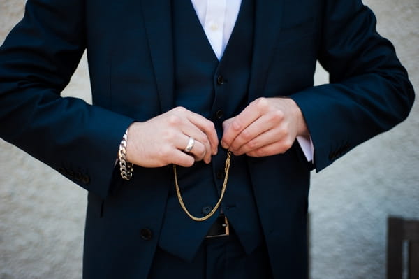 Groom buttoning waistcoat