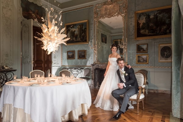 Bride and groom sitting in Blue Room at Waddesdon Manor