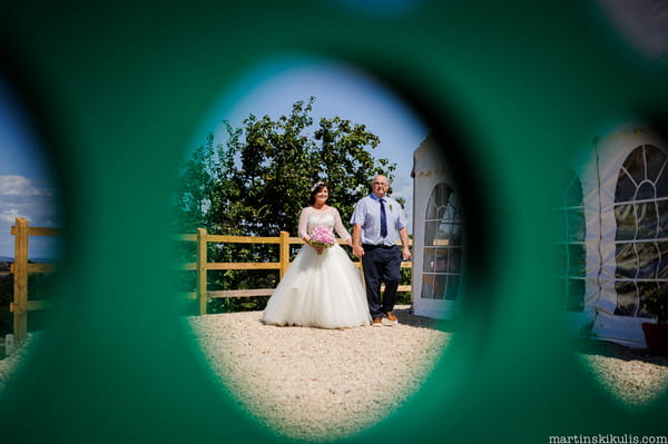 Bride walking with father