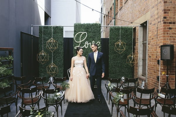 Bride and groom looking at each other for urban chic wedding ceremony