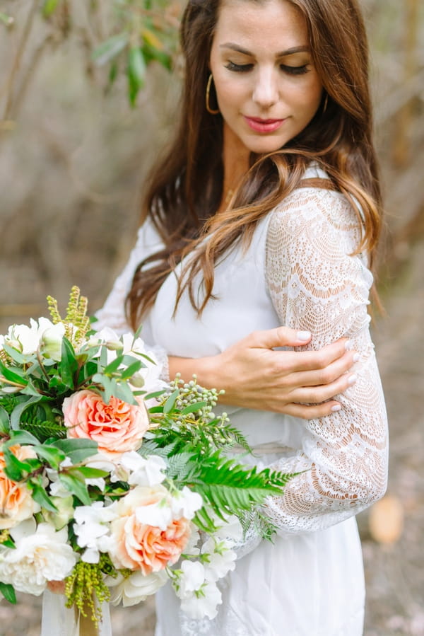 Bride touching lace detailed sleeve