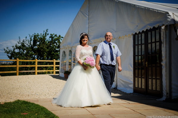 Bride walking to ceremony with father