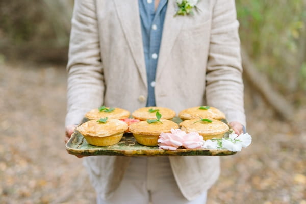 Groom holding tray of pies