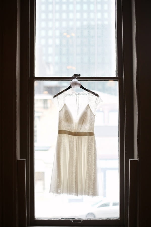 Wedding dress hanging in window