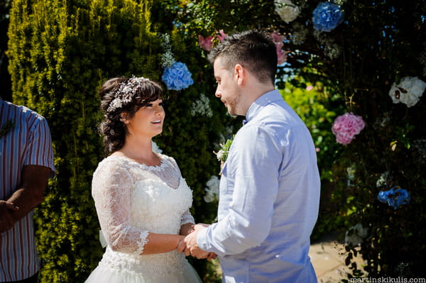 Bride and groom holding hands