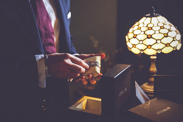 Groom taking watch out of box