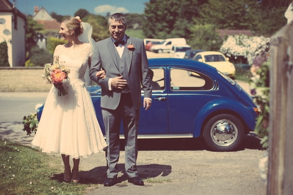 Father walking bride from car