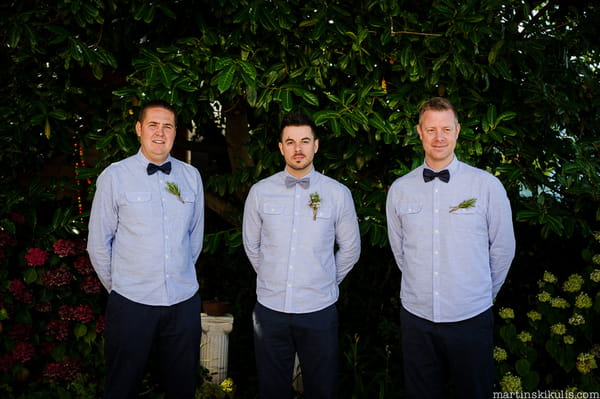 Groomsmen in blue shirts and bow ties