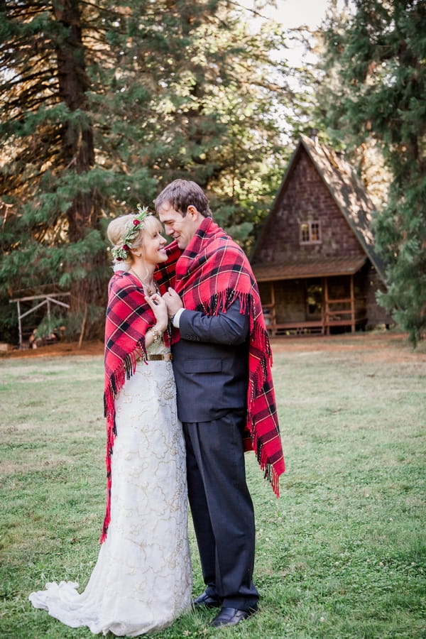 Bride and groom wrapped in blanket