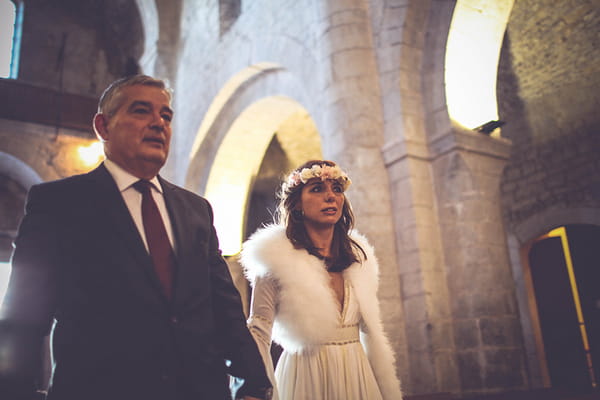 Bride walking down aisle with father