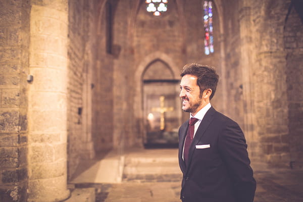 Groom smiling in church