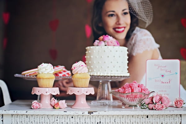 Bride sitting at wedding dessert trolley