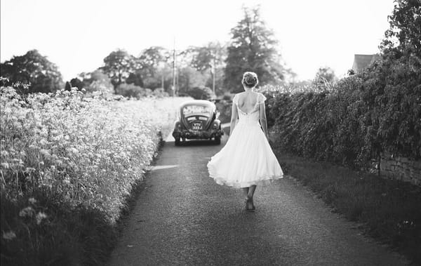 Bride walking down country lane