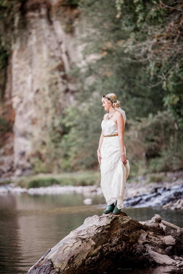 Bride standing on rock