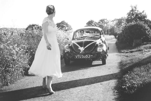 Bride standing in front of VW Beetle